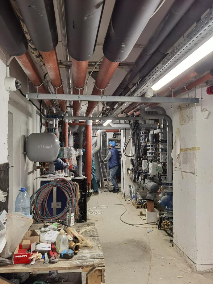Two Amber Technicians working on the installation of a complete Central heating system for Olga Gudynn International School