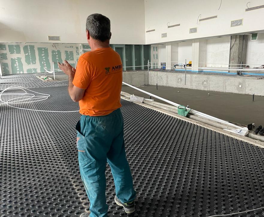 underfloor heating system installation Amber technician working on the installation of the underfloor heating system at Olga Gudynn International School’s swimming pool